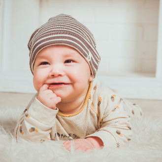 four month old baby crawling on floor